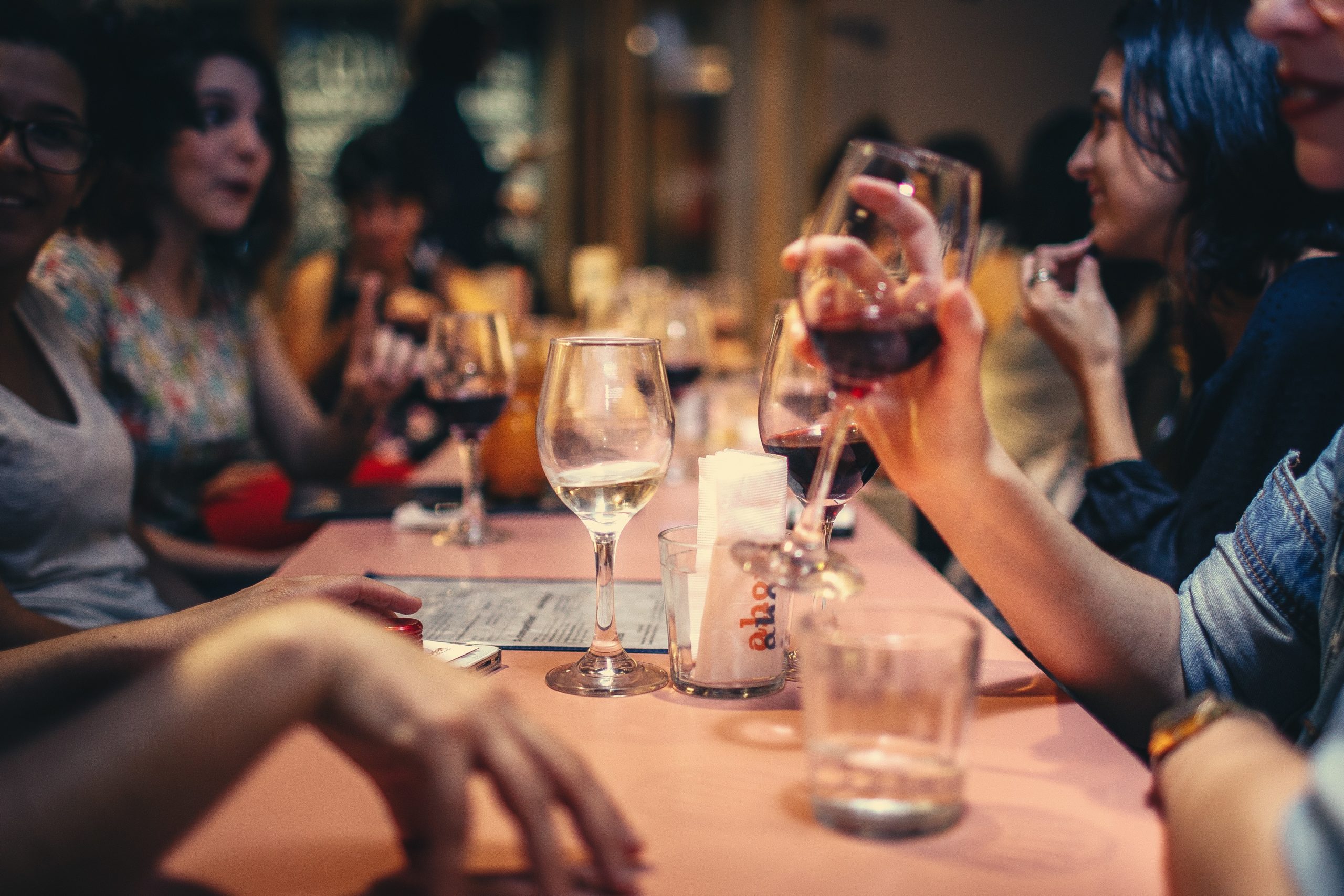 women with wine glasses networking at a restaurant